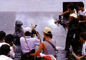 File:Godzilla gets sprayed by Mothra silk machine.jpg
