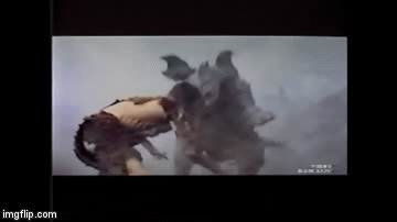 File:Baragon foolishly jumps down the side of a mountain.gif
